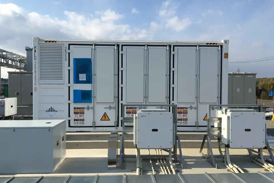 屋外のコンクリート基礎に設置された白いコンテナ型蓄電設備